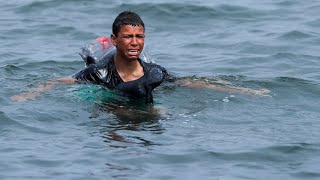 Ceuta Migrant boy swims to shore with plastic bottles tied to himself [upl. by Cate]